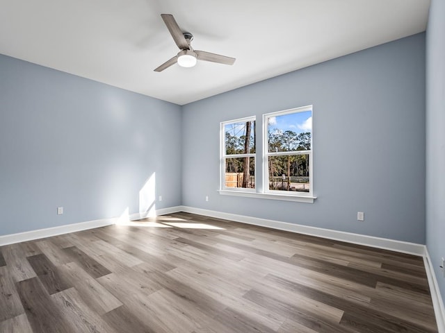 spare room featuring hardwood / wood-style floors and ceiling fan