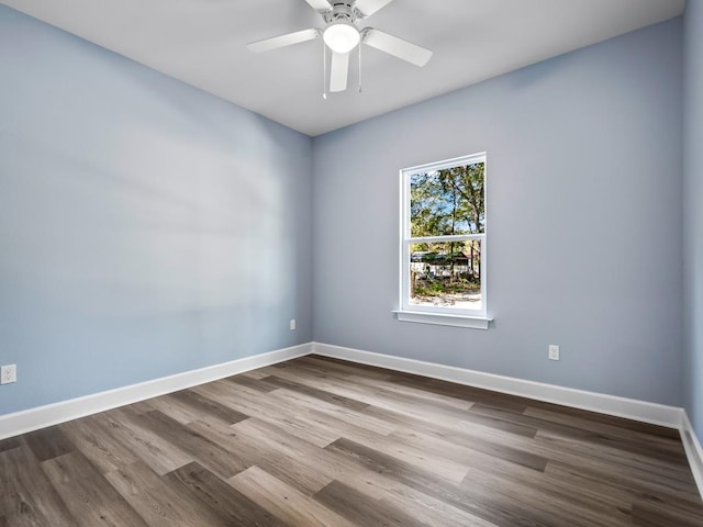 unfurnished room featuring hardwood / wood-style flooring and ceiling fan