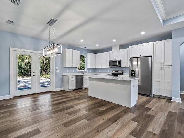 kitchen with white cabinets, a wealth of natural light, appliances with stainless steel finishes, and french doors