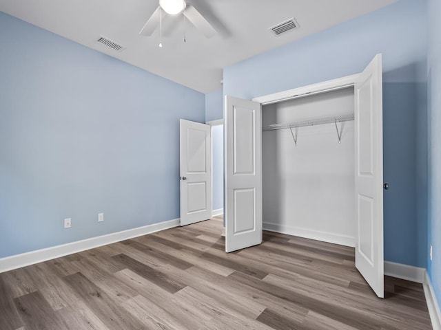 unfurnished bedroom featuring a closet, ceiling fan, and light hardwood / wood-style flooring