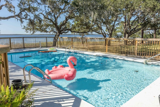 view of swimming pool with a water view