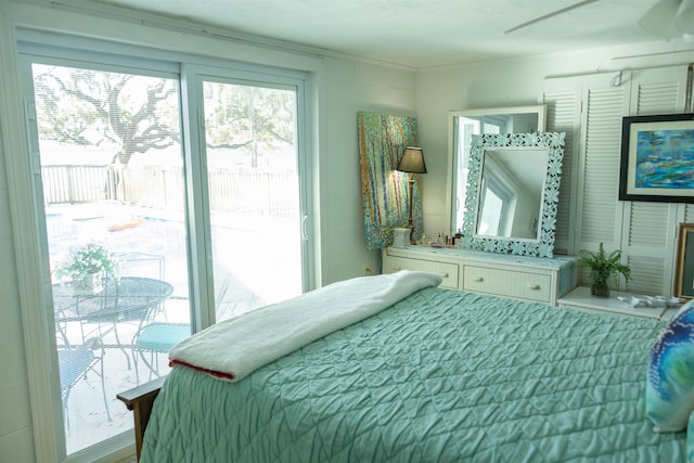 bedroom with access to outside and ceiling fan