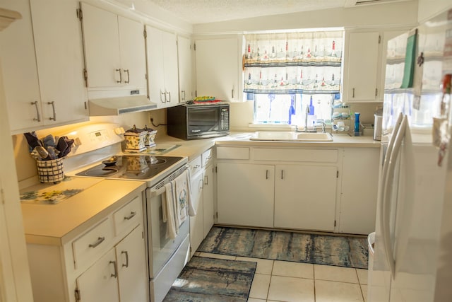 kitchen featuring white cabinetry, sink, a textured ceiling, light tile patterned floors, and white appliances