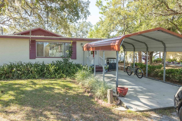 view of front facade with a front yard and a carport