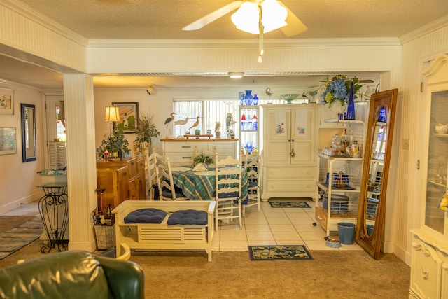 carpeted dining space featuring a textured ceiling, ceiling fan, and crown molding