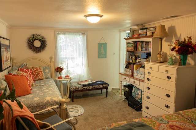 bedroom featuring a textured ceiling, light carpet, and crown molding