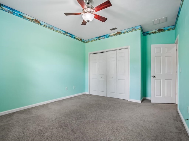 unfurnished bedroom with a closet, carpet flooring, and ceiling fan