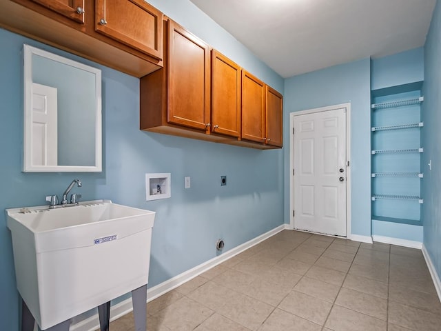 washroom with cabinets, sink, washer hookup, light tile patterned floors, and electric dryer hookup