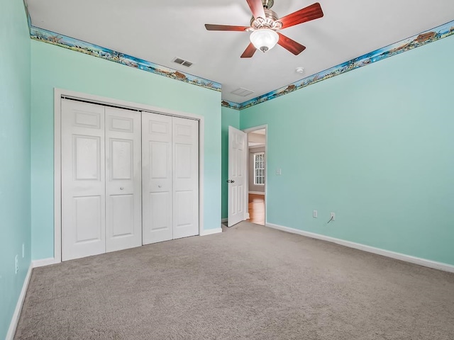 unfurnished bedroom featuring a closet, ceiling fan, and carpet floors