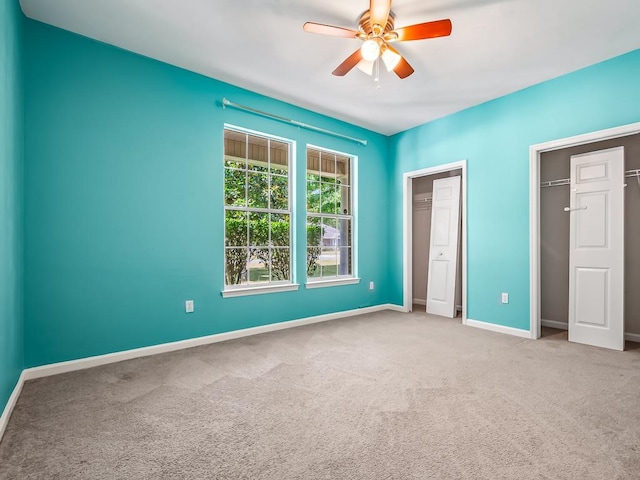 unfurnished bedroom featuring carpet and ceiling fan