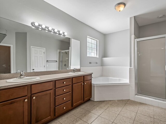 bathroom with tile patterned flooring, shower with separate bathtub, and vanity