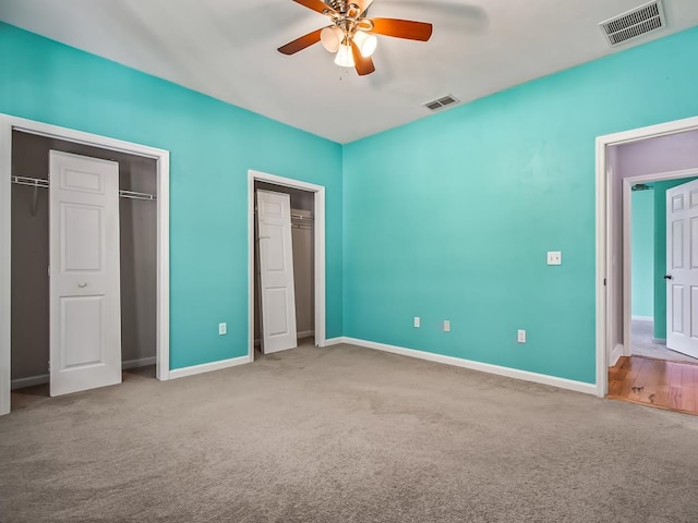 unfurnished bedroom featuring light colored carpet and ceiling fan