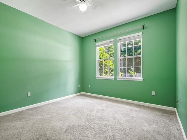 empty room with carpet flooring and ceiling fan