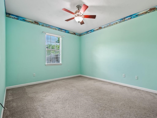 spare room featuring carpet and ceiling fan