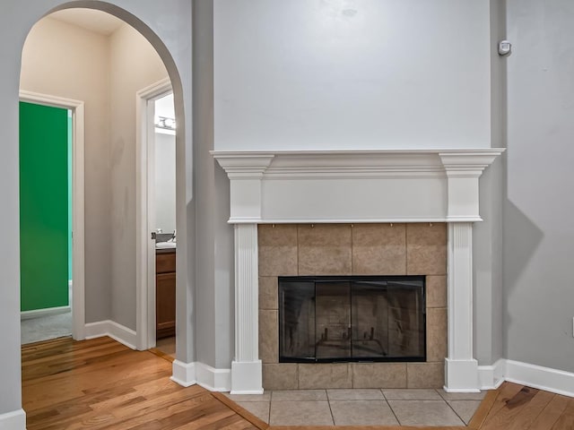 interior details with a fireplace and wood-type flooring