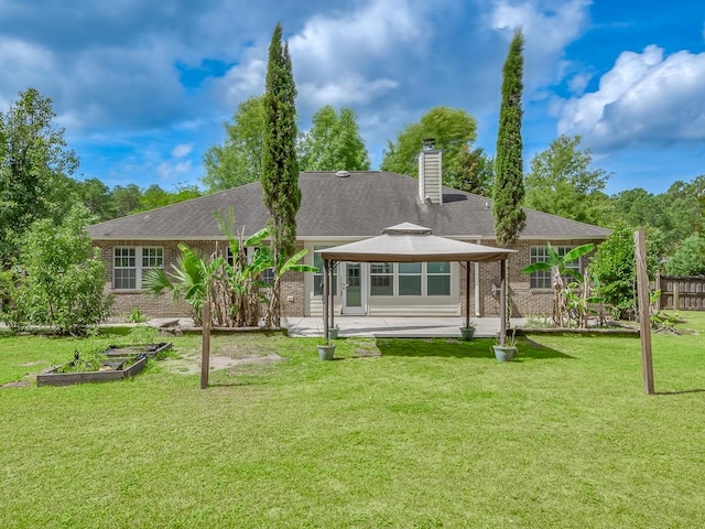 rear view of house featuring a yard, a gazebo, and a patio area