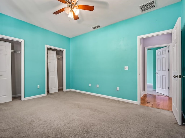 unfurnished bedroom with light carpet and ceiling fan