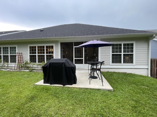 back of house with a yard and a patio area