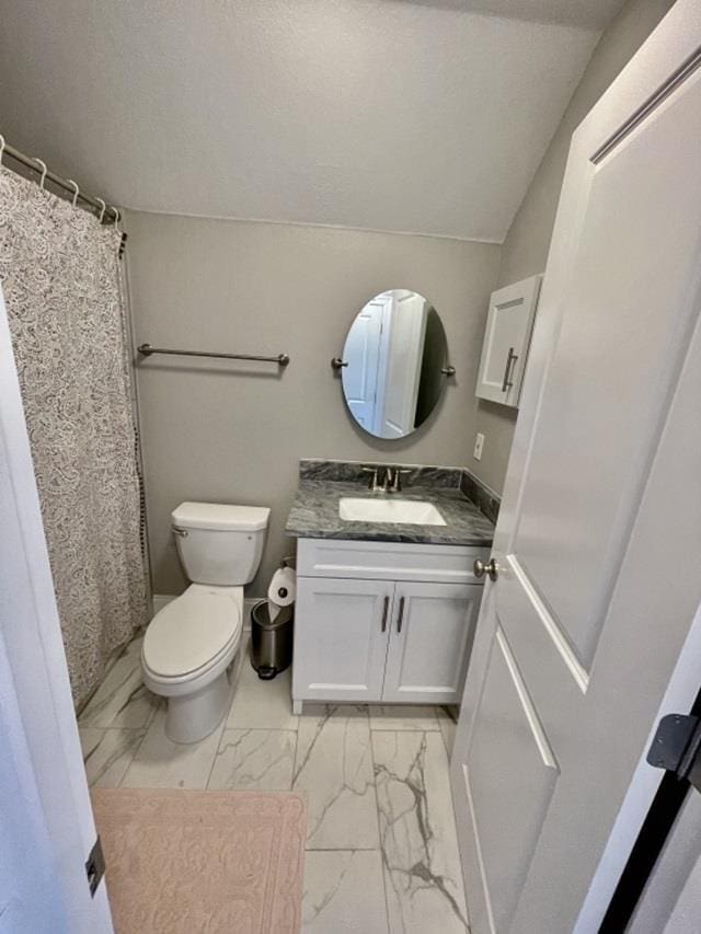 bathroom with vanity, a textured ceiling, and toilet