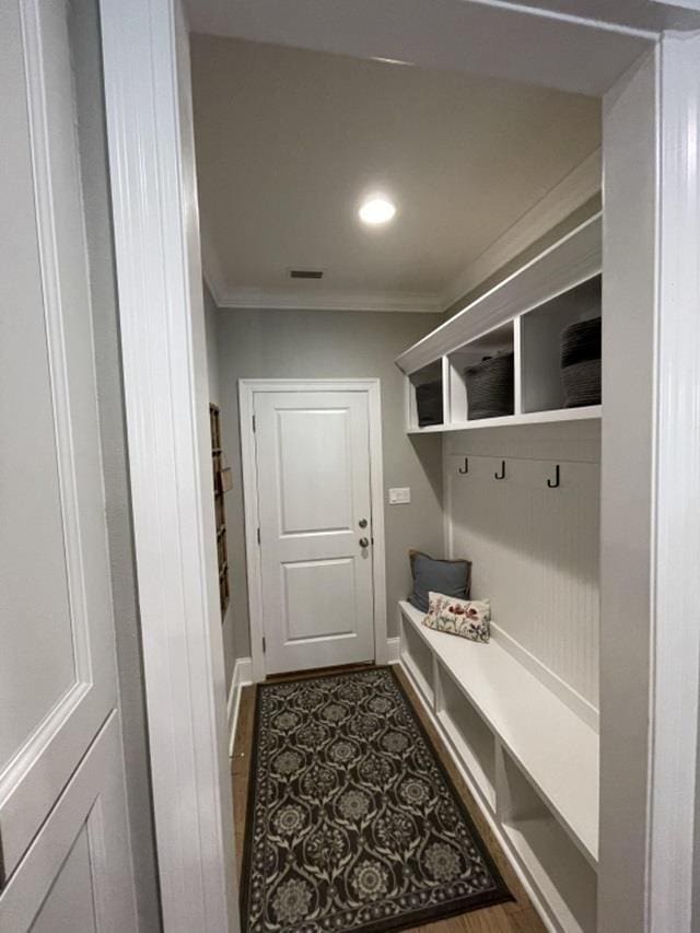 mudroom with crown molding and dark hardwood / wood-style flooring