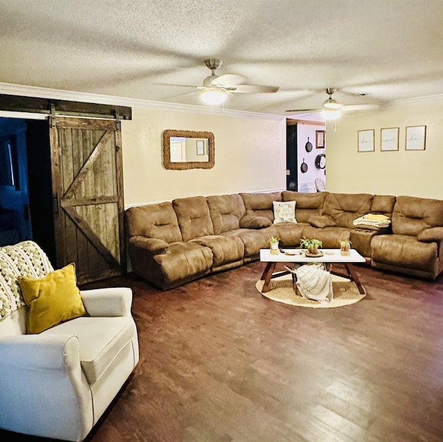 living room featuring ceiling fan, a textured ceiling, and ornamental molding