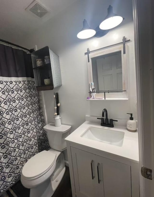 bathroom with toilet, a shower with shower curtain, and vanity