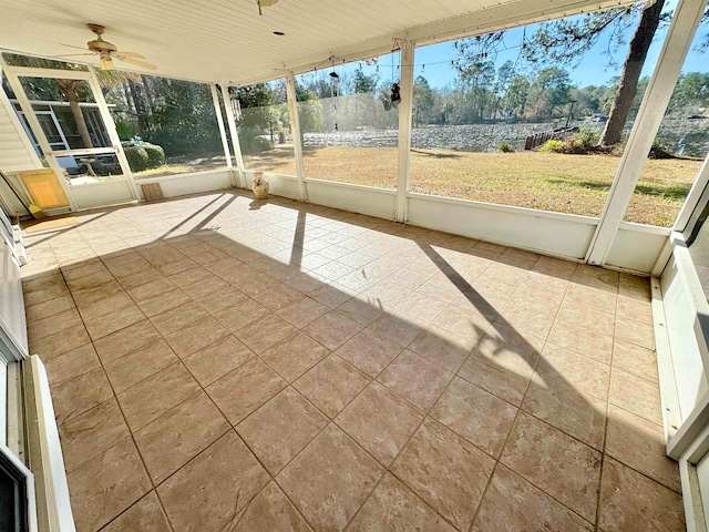 unfurnished sunroom with ceiling fan and wooden ceiling