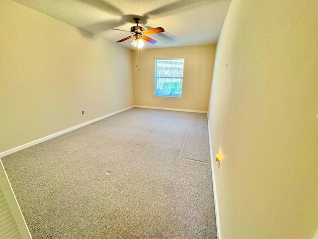 empty room with carpet, a textured ceiling, and ceiling fan