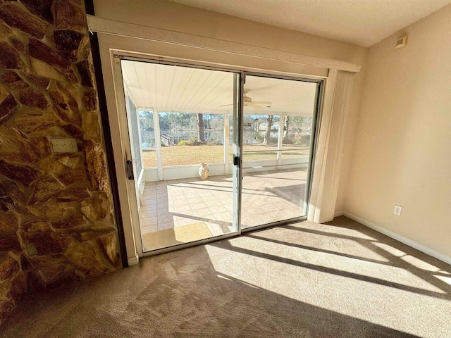 doorway featuring a textured ceiling and carpet flooring