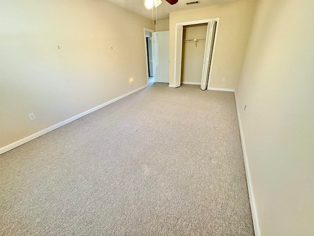 unfurnished bedroom featuring a closet, light carpet, and ceiling fan