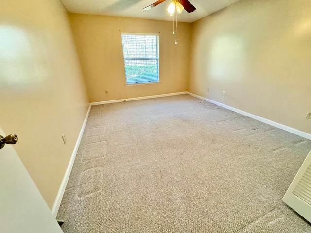 spare room featuring ceiling fan and carpet floors