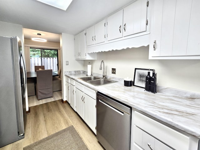 2840 Blair Stone Ct, Tallahassee, FL 32301 - kitchen featuring appliances with stainless steel finishes, light wood-type flooring, light countertops, and white cabinetry