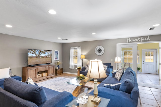 living room with light tile patterned floors and a wealth of natural light