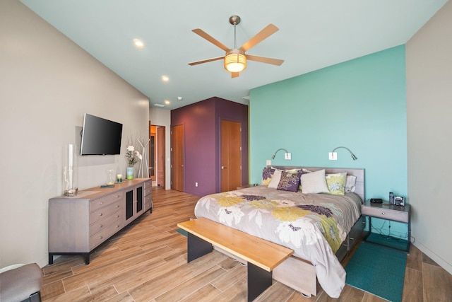 bedroom with light wood-type flooring and ceiling fan