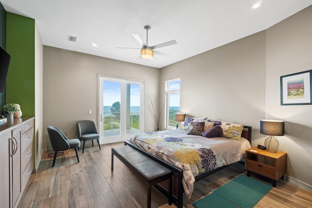 bedroom with hardwood / wood-style flooring, access to outside, and ceiling fan