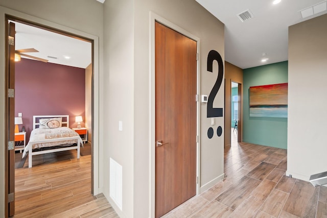 corridor with light hardwood / wood-style flooring