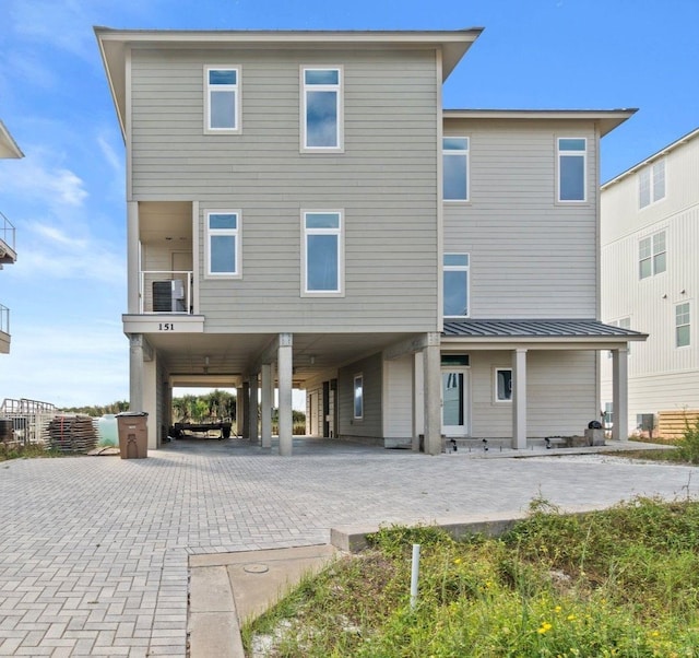 rear view of property featuring a carport