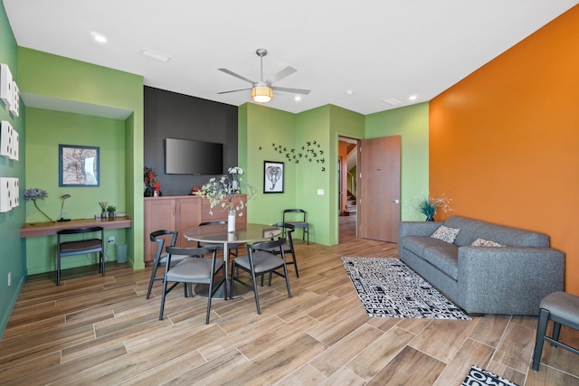 dining room with light wood-type flooring and ceiling fan