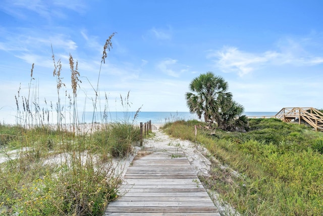 exterior space featuring a beach view and a water view