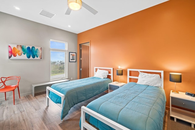 bedroom with hardwood / wood-style flooring and ceiling fan