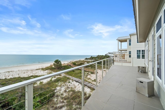 balcony with a view of the beach and a water view