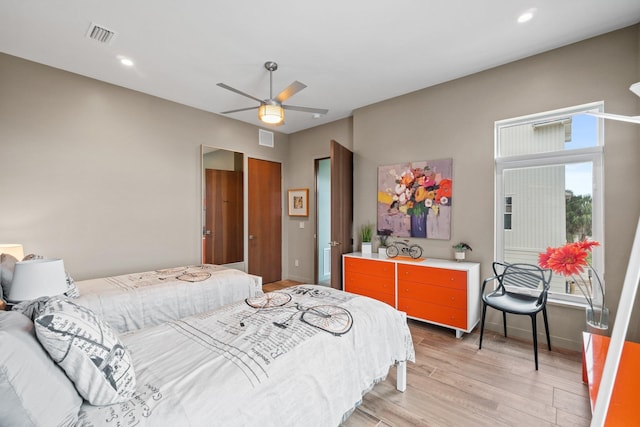 bedroom with light hardwood / wood-style flooring and ceiling fan