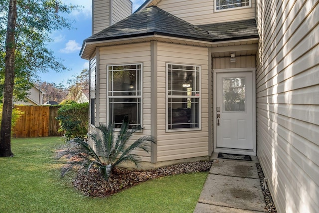 doorway to property featuring a yard