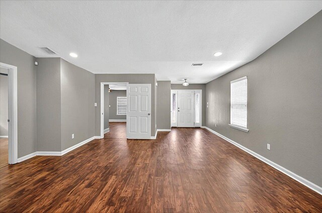 3974 Paeonia Ct, Tallahassee, FL 32305 - unfurnished living room with baseboards, dark wood-style floors, recessed lighting, and a textured ceiling