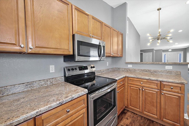 3974 Paeonia Ct, Tallahassee, FL 32305 - kitchen featuring stainless steel appliances, a chandelier, dark wood finished floors, a peninsula, and recessed lighting