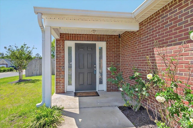3974 Paeonia Ct, Tallahassee, FL 32305 - view of exterior entry featuring brick siding and a lawn