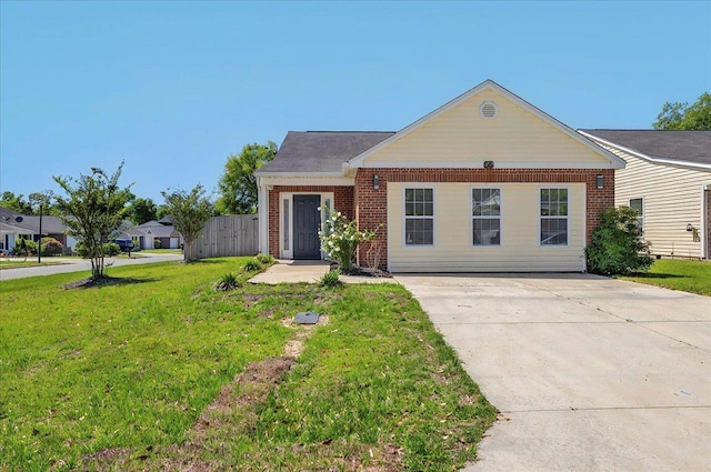 3974 Paeonia Ct, Tallahassee, FL 32305 - view of front of home with brick siding, a front lawn, and concrete driveway