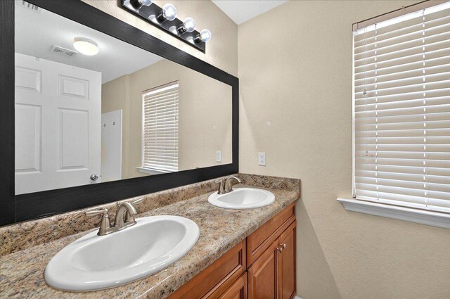 3974 Paeonia Ct, Tallahassee, FL 32305 - full bath with double vanity and a textured wall