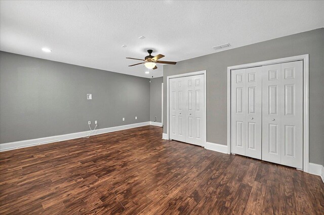 3974 Paeonia Ct, Tallahassee, FL 32305 - unfurnished bedroom featuring baseboards, dark wood-style flooring, multiple closets, recessed lighting, and a ceiling fan