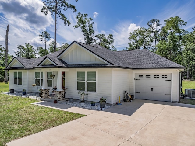 103 Pan Cera Dr, Crawfordville, FL 32327 - view of front facade featuring board and batten siding, an attached garage, driveway, a front lawn, and a shingled roof